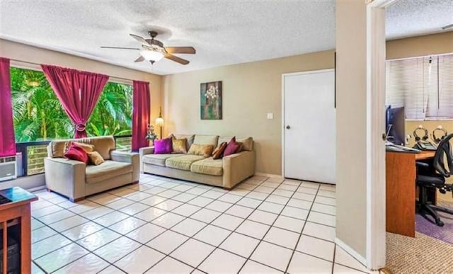 living room with a textured ceiling, light tile patterned floors, and ceiling fan