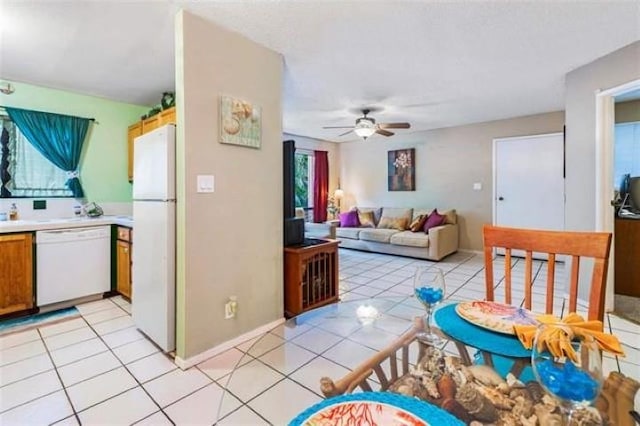 kitchen with white appliances, ceiling fan, and light tile patterned floors