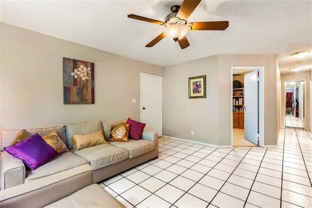 living room with ceiling fan and light tile patterned floors