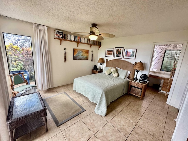 bedroom featuring light tile patterned flooring, access to exterior, ceiling fan, and a textured ceiling