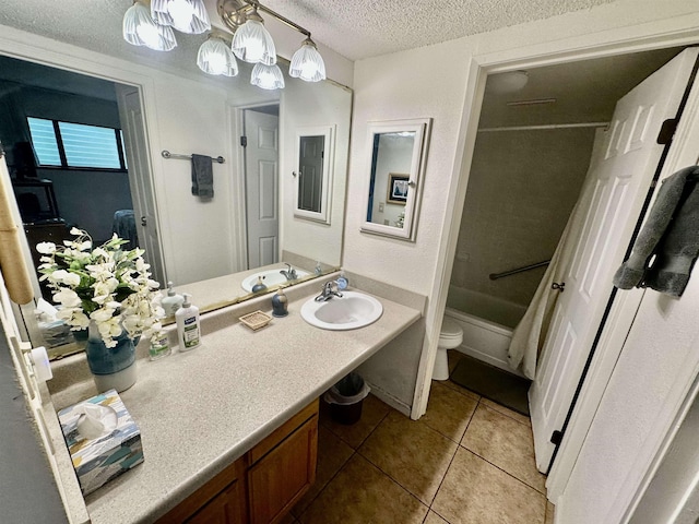 full bathroom featuring tub / shower combination, tile patterned flooring, vanity, a textured ceiling, and toilet