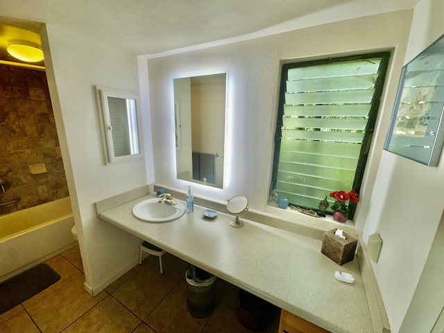 full bathroom featuring toilet, tile patterned flooring, sink, and shower / bathing tub combination