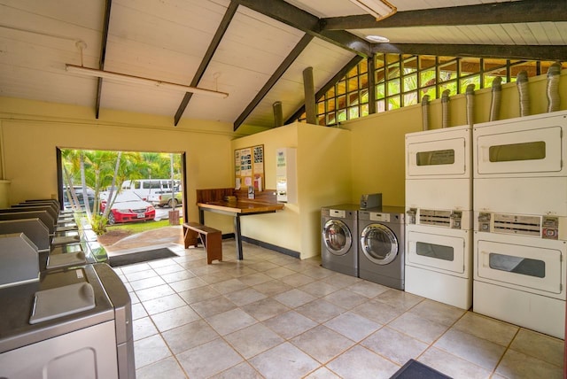 washroom with stacked washer and dryer and light tile patterned floors