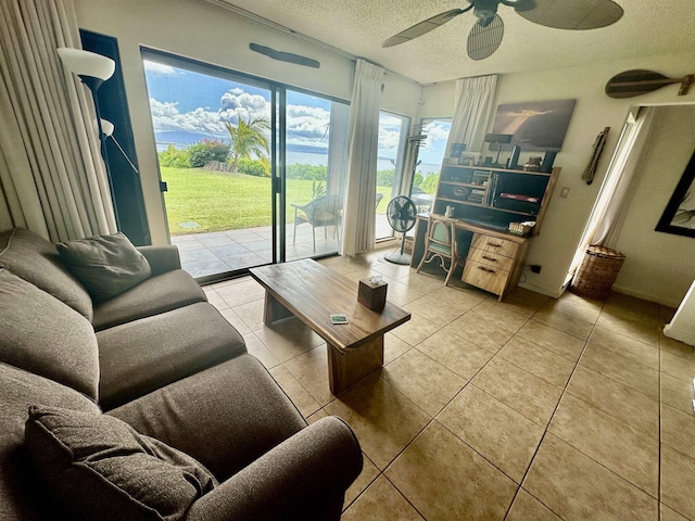 tiled living room featuring ceiling fan and a textured ceiling