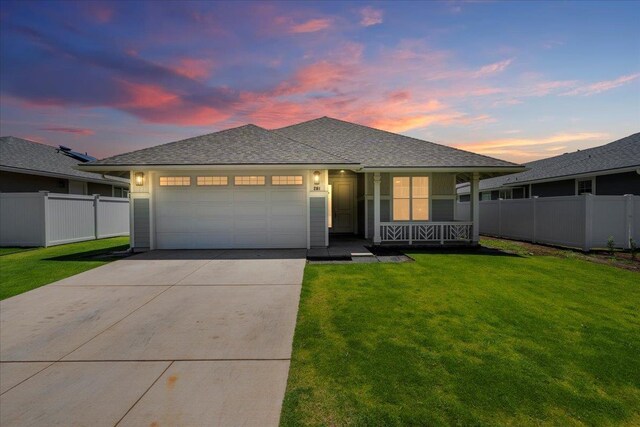 ranch-style house featuring a yard, driveway, fence, covered porch, and an attached garage
