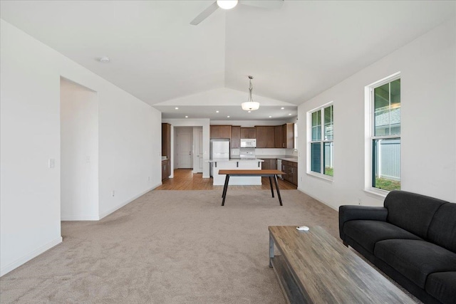 living area with a ceiling fan, recessed lighting, baseboards, vaulted ceiling, and light carpet