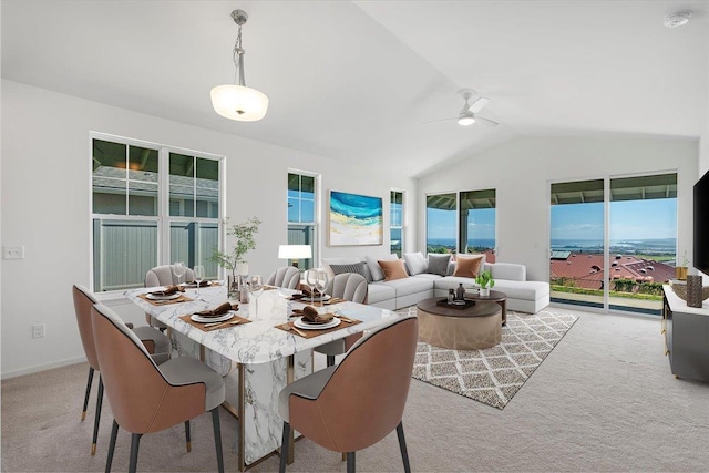 dining area with lofted ceiling, light carpet, ceiling fan, and baseboards