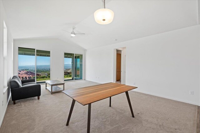office featuring a ceiling fan, light carpet, baseboards, and lofted ceiling