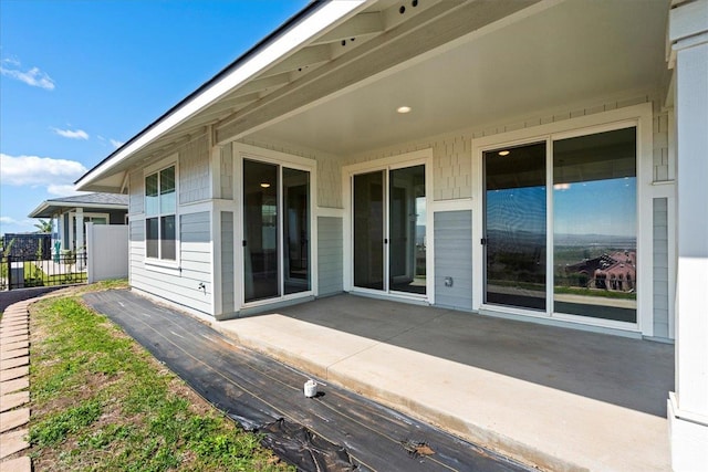 back of property featuring a patio and fence