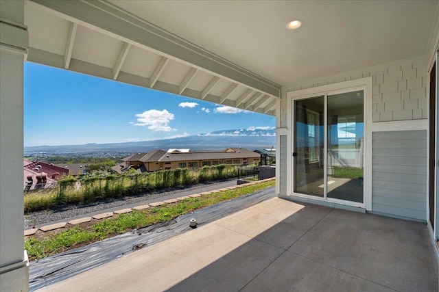 balcony with a mountain view and a patio