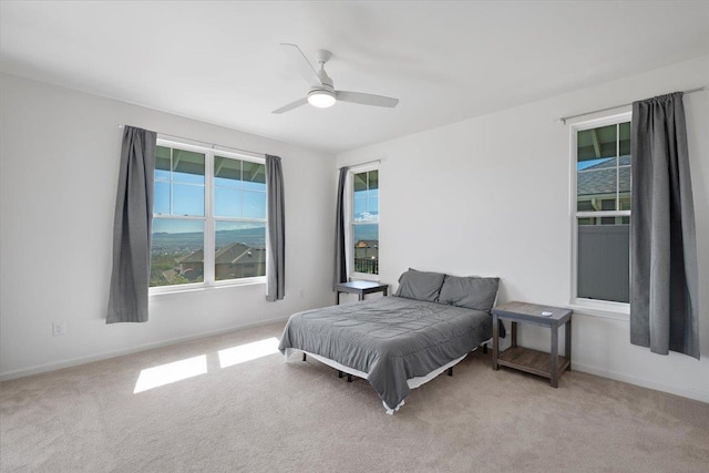 bedroom with carpet, baseboards, and ceiling fan