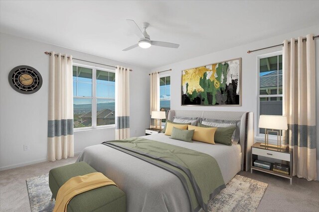 carpeted bedroom featuring baseboards and a ceiling fan