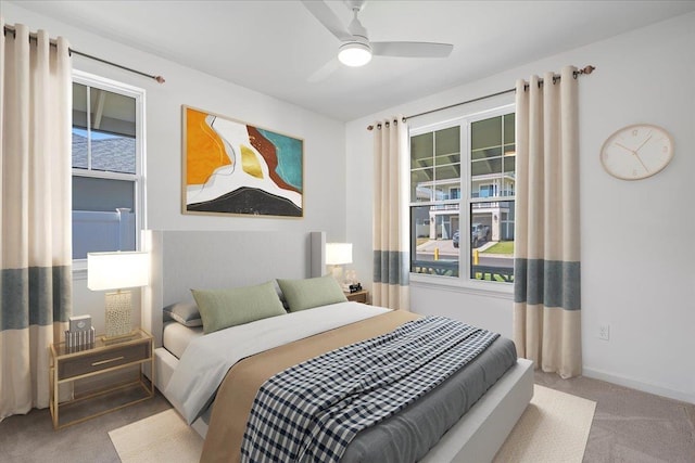 carpeted bedroom with baseboards and ceiling fan