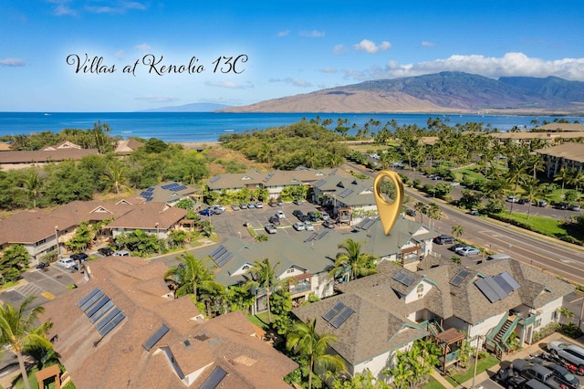 birds eye view of property with a water and mountain view