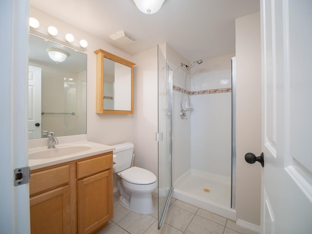 bathroom featuring toilet, tile patterned flooring, walk in shower, and vanity