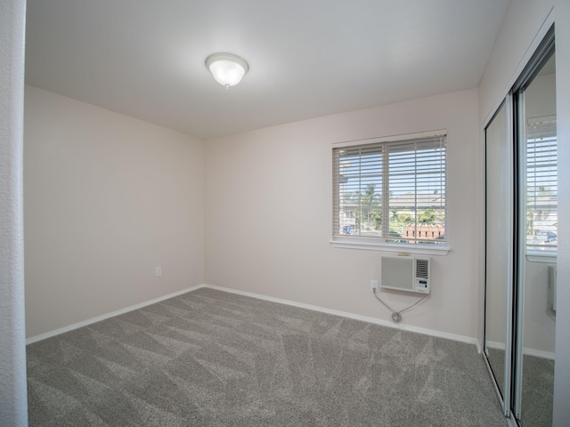 carpeted empty room with a wall mounted AC