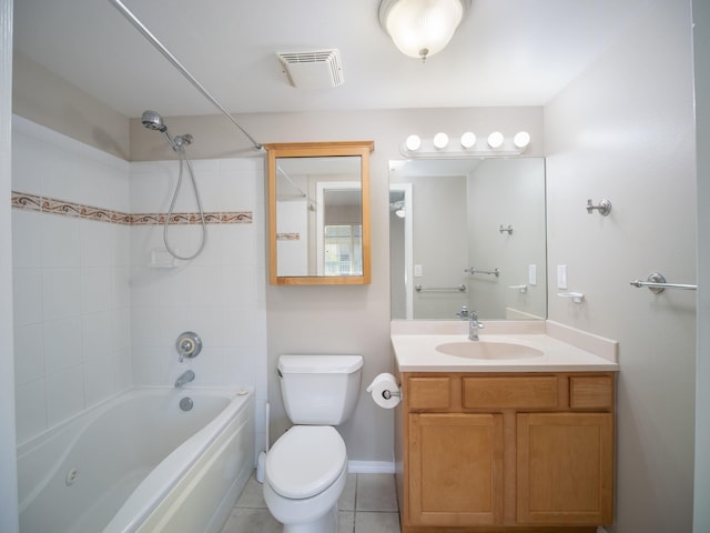 full bathroom with vanity, toilet, tiled shower / bath, and tile patterned floors