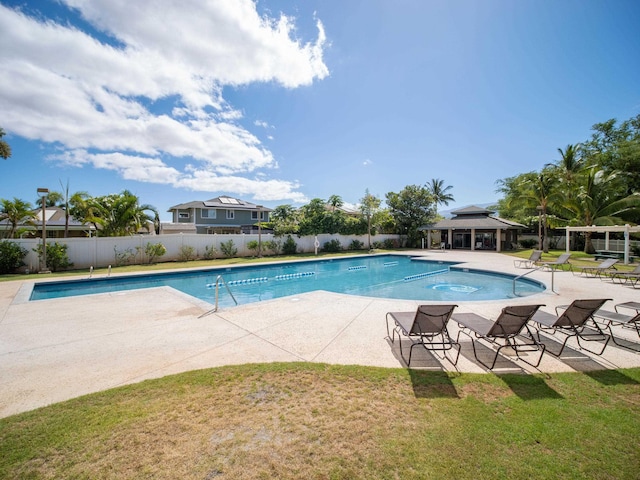 view of pool featuring a patio area and a yard