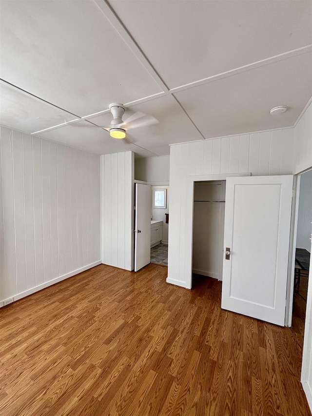 unfurnished bedroom with wood finished floors and a ceiling fan