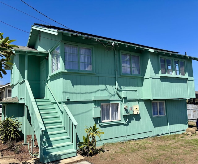 view of side of home featuring stairs