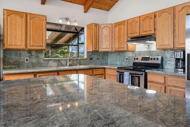 kitchen featuring vaulted ceiling with beams, under cabinet range hood, decorative backsplash, stainless steel range with electric stovetop, and a sink