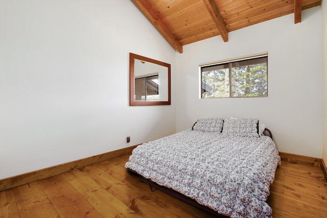 bedroom with hardwood / wood-style floors, lofted ceiling with beams, wood ceiling, and baseboards