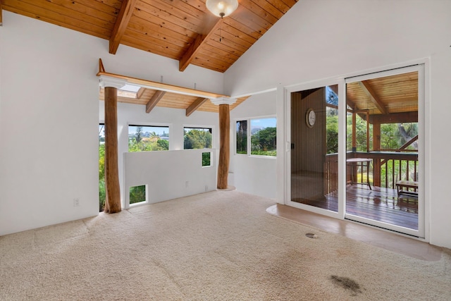 empty room featuring wooden ceiling, beamed ceiling, carpet flooring, and high vaulted ceiling