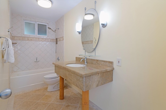 bathroom with tile patterned floors, toilet, shower / bathtub combination, and a sink