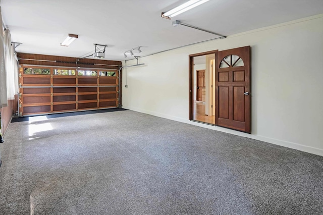 garage with a garage door opener and baseboards