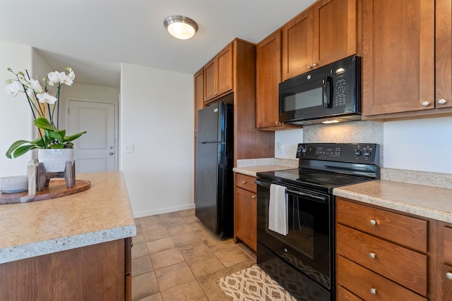 kitchen featuring black appliances, light tile patterned floors, and backsplash