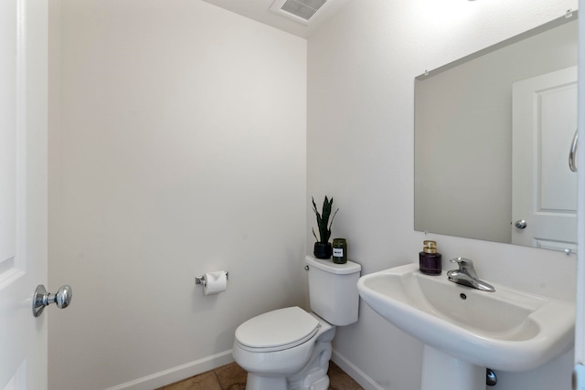 bathroom featuring tile patterned flooring, toilet, and sink