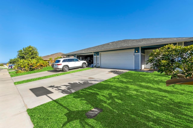 single story home featuring a garage and a front lawn