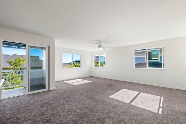 unfurnished room with ceiling fan and carpet