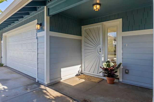 doorway to property with a garage