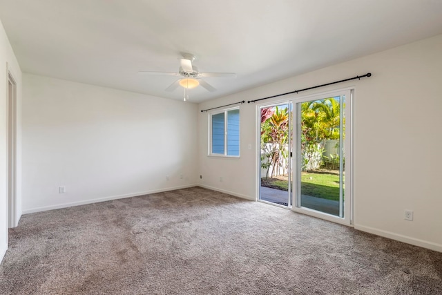 carpeted spare room featuring ceiling fan