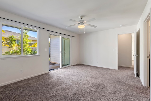 carpeted spare room with ceiling fan