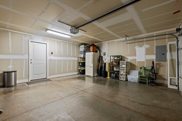 garage with electric panel, a garage door opener, and white refrigerator