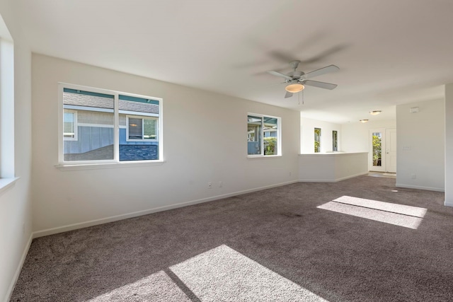 carpeted empty room with plenty of natural light and ceiling fan