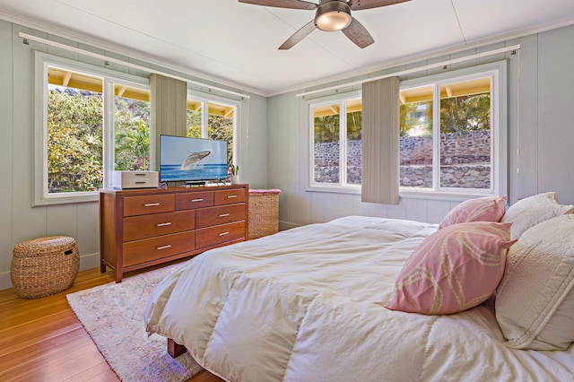 219 Ekoa Pl, Wailuku, HI 96763 - bedroom featuring wood finished floors, ceiling fan, and a decorative wall