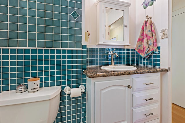 219 Ekoa Pl, Wailuku, HI 96763 - bathroom featuring toilet, tile walls, and vanity