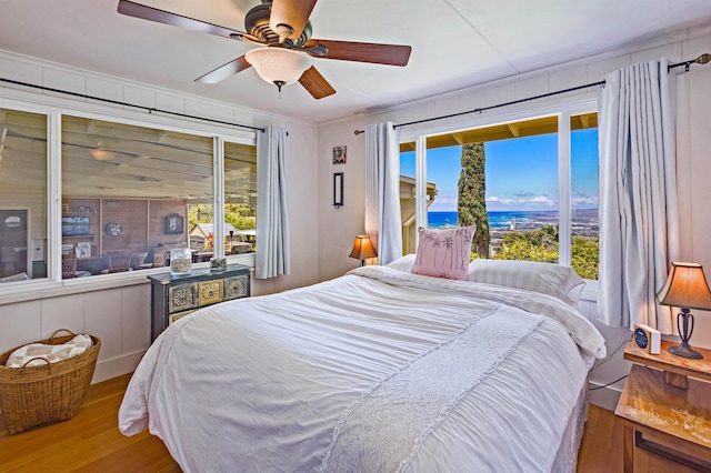 219 Ekoa Pl, Wailuku, HI 96763 - bedroom with wood finished floors, access to exterior, ceiling fan, and a water view