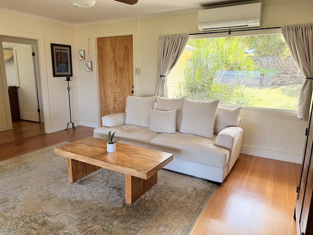 219 Ekoa Pl, Wailuku, HI 96763 - living area with a wall mounted air conditioner, wood finished floors, ornamental molding, healthy amount of natural light, and ceiling fan