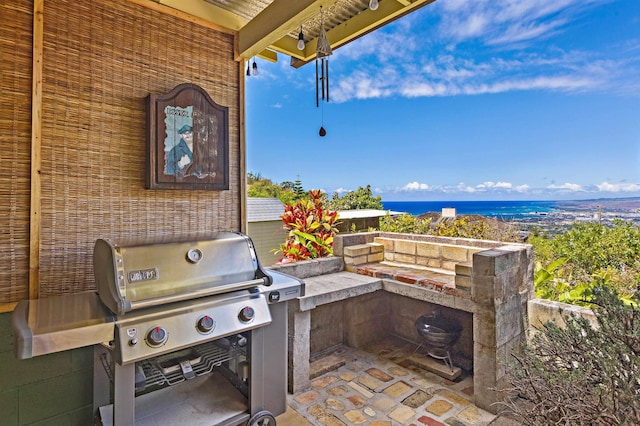 219 Ekoa Pl, Wailuku, HI 96763 - view of patio / terrace featuring grilling area and a water view