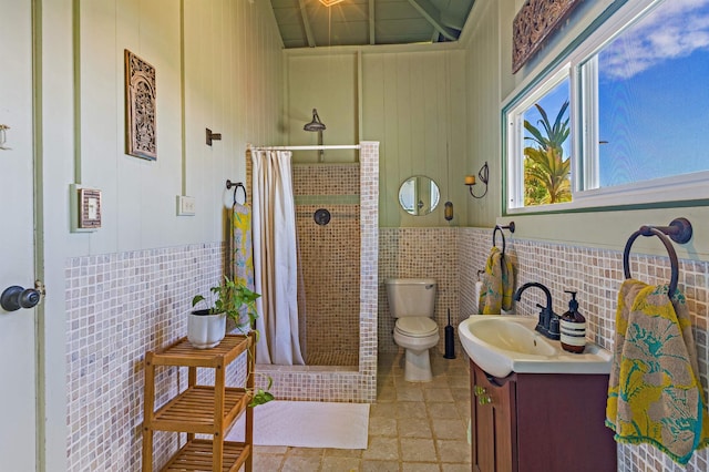 219 Ekoa Pl, Wailuku, HI 96763 - bathroom featuring vanity, a stall shower, toilet, and tile walls