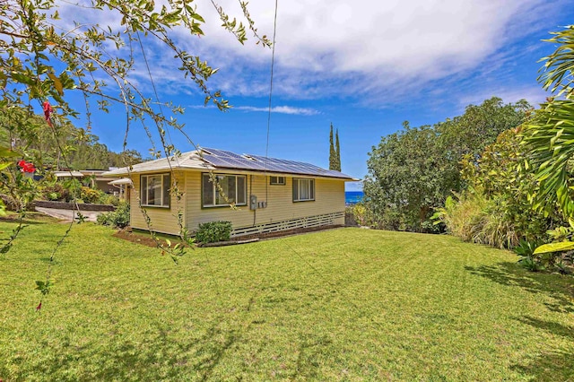 219 Ekoa Pl, Wailuku, HI 96763 - view of property exterior with solar panels and a lawn