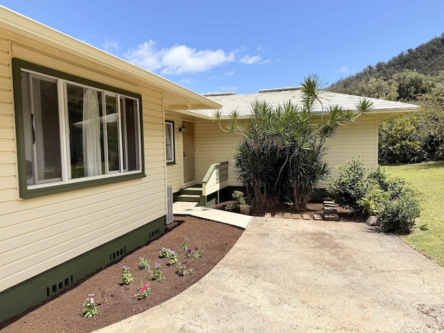 219 Ekoa Pl, Wailuku, HI 96763 - view of exterior entry with crawl space and a patio