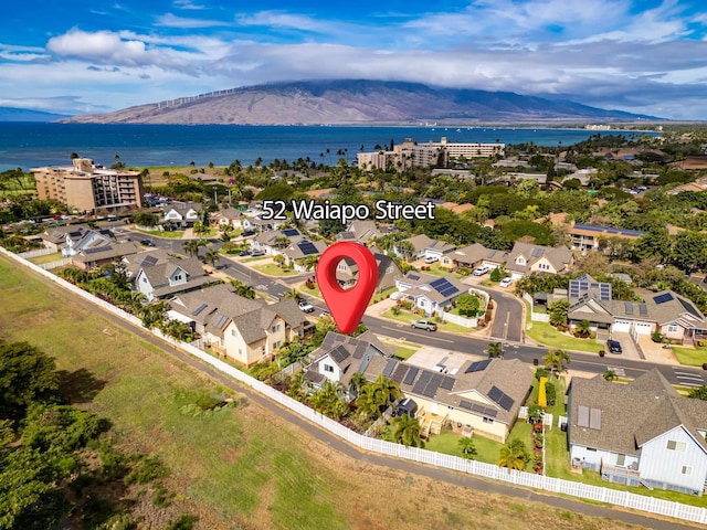 drone / aerial view featuring a water and mountain view