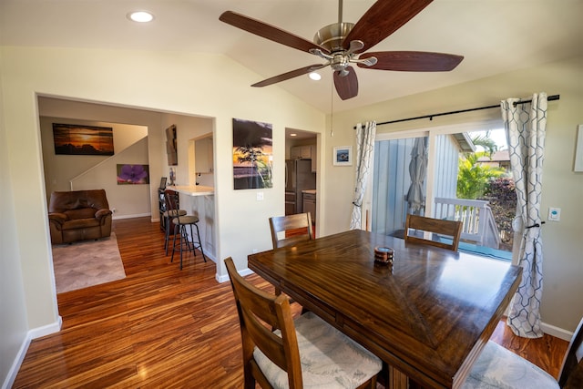 dining space featuring lofted ceiling, dark wood-type flooring, and ceiling fan