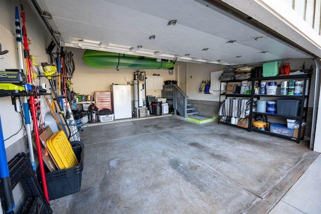 garage with white fridge and secured water heater