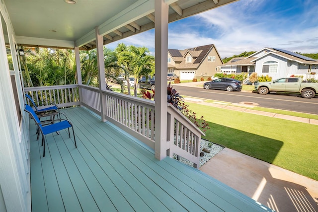 wooden deck featuring a yard and covered porch